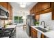 Eat-in kitchen boasts stainless appliances, and a view of the back deck at 3390 Kenland Se Rd, Smyrna, GA 30082