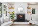 Cozy living room with a fireplace, floating shelves, and comfortable seating at 3390 Kenland Se Rd, Smyrna, GA 30082