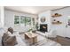 Bright living room with fireplace, neutral furniture, and large windows at 3390 Kenland Se Rd, Smyrna, GA 30082