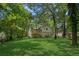 Spacious backyard features a well-maintained lawn and mature trees, perfect for outdoor activities at 4030 Tanglewood Rd, Snellville, GA 30039