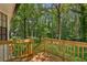 Wooden deck with steps overlooking the backyard and tree line at 4030 Tanglewood Rd, Snellville, GA 30039