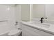 Modern bathroom with quartz countertop, vanity, and tub with shower at 4030 Tanglewood Rd, Snellville, GA 30039