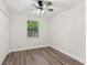 A bedroom with wood look floors and a ceiling fan is naturally lit by a window at 4030 Tanglewood Rd, Snellville, GA 30039