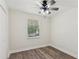 A naturally lit bedroom includes wood look flooring and a ceiling fan at 4030 Tanglewood Rd, Snellville, GA 30039