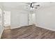 A well lit bedroom features a ceiling fan and wood look flooring at 4030 Tanglewood Rd, Snellville, GA 30039