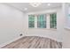 Cozy breakfast nook with large windows providing ample natural light and new wood-look flooring at 4030 Tanglewood Rd, Snellville, GA 30039
