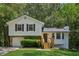 Charming two-story home with white siding, stone accents, and a well-manicured front yard at 4030 Tanglewood Rd, Snellville, GA 30039