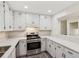 Modern kitchen featuring white cabinetry, stainless steel appliances, and updated countertops at 4030 Tanglewood Rd, Snellville, GA 30039