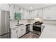 Updated kitchen with white cabinets, stainless steel appliances, and quartz countertops at 4030 Tanglewood Rd, Snellville, GA 30039