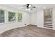 Inviting living room with large windows, new wood-look floors, and staircase at 4030 Tanglewood Rd, Snellville, GA 30039