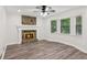 Cozy living room featuring a stone fireplace, large windows, and stylish flooring at 4030 Tanglewood Rd, Snellville, GA 30039
