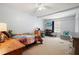 Large bedroom with a bed, desk, TV, and a cozy sitting area at 6223 Emerald Springs Se Dr, Acworth, GA 30102