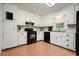 Charming kitchen with white cabinetry, black appliances, and bright lighting at 6223 Emerald Springs Se Dr, Acworth, GA 30102