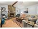 Bright living room with stone fireplace, wood-look floors, and comfy seating at 6223 Emerald Springs Se Dr, Acworth, GA 30102
