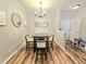 Cozy dining room featuring a wood table with four chairs, accented by a stylish chandelier at 1975 Nocturne Dr # 2206, Alpharetta, GA 30009