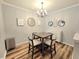 Chic dining room with modern chandelier, square wood table and four padded chairs at 1975 Nocturne Dr # 2206, Alpharetta, GA 30009