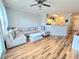 Open-concept living room with a large sectional sofa, coffee table and ceiling fan at 1975 Nocturne Dr # 2206, Alpharetta, GA 30009
