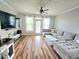 Spacious living room with hardwood floors, a comfortable sectional sofa, and plenty of natural light at 1975 Nocturne Dr # 2206, Alpharetta, GA 30009