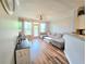 Bright living room featuring hardwood floors, comfortable sectional sofa, and natural light at 1975 Nocturne Dr # 2206, Alpharetta, GA 30009