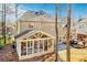 Spacious backyard featuring a screened-in porch, patio area, and lush landscaping at 380 Victorian Ln, Duluth, GA 30097