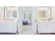 This primary bath has double vanities, framed mirrors, and entry doors at 380 Victorian Ln, Duluth, GA 30097