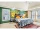 The bedroom has a leaf paint mural with a bed, rug, and two windows at 380 Victorian Ln, Duluth, GA 30097