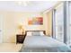 This bedroom features a painting over the bed with natural light from the windows at 380 Victorian Ln, Duluth, GA 30097