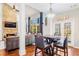 Inviting dining area with stone fireplace, chandelier, and glass doors leading to the outdoor space at 380 Victorian Ln, Duluth, GA 30097