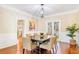 Elegant dining room with wood floors, stylish lighting, a large table, and ample seating at 380 Victorian Ln, Duluth, GA 30097