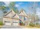 Charming two-story home with a three-car garage and stone detailing on the exterior at 380 Victorian Ln, Duluth, GA 30097