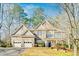 Charming two-story home with a three-car garage and stone detailing on the exterior at 380 Victorian Ln, Duluth, GA 30097