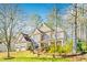 Charming two-story home with a three-car garage and stone detailing on the exterior at 380 Victorian Ln, Duluth, GA 30097
