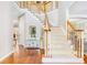 Grand foyer featuring a curved staircase with wood and white railing at 380 Victorian Ln, Duluth, GA 30097