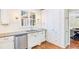 Modern kitchen with white cabinets, stainless steel appliances, light countertops, and ample storage space at 380 Victorian Ln, Duluth, GA 30097