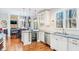 Modern kitchen with white cabinets, stainless steel appliances, light countertops, and a wine fridge at 380 Victorian Ln, Duluth, GA 30097
