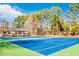 Brightly colored tennis courts surrounded by mature trees and blue sky at 380 Victorian Ln, Duluth, GA 30097