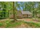 Backyard featuring lush trees, green grass, and the back of the home at 425 Shelby Ln, Hiram, GA 30141