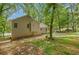 Spacious backyard featuring a well-maintained lawn, mature trees, and the exterior of the home at 425 Shelby Ln, Hiram, GA 30141
