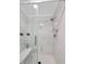 Bathroom showcasing a glass shower, white marble tiling, and built-in bench at 425 Shelby Ln, Hiram, GA 30141