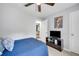 Bedroom features ceiling fan, television on dresser, with a queen bed at 425 Shelby Ln, Hiram, GA 30141