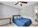 Comfortable bedroom with ceiling fan, desk, and cozy bed with blue comforter at 425 Shelby Ln, Hiram, GA 30141
