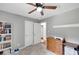 Home office and bedroom featuring a ceiling fan, cabinets, and a comfortable work space at 425 Shelby Ln, Hiram, GA 30141