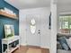 Stylish entryway with a white front door, a modern table, and an adjacent living room at 425 Shelby Ln, Hiram, GA 30141