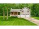 Attractive two-story home with a well-kept lawn, a covered front porch, and an attached two-car garage at 425 Shelby Ln, Hiram, GA 30141