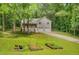 Inviting two-story home with a well-manicured lawn, an attached two-car garage, and garden beds in the front yard at 425 Shelby Ln, Hiram, GA 30141