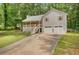 Charming home with a welcoming porch, two-car garage, a long driveway, and neatly landscaped front yard at 425 Shelby Ln, Hiram, GA 30141