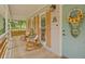 Charming front porch with rocking chairs, a wooden deck, and a decorative sunflower wreath on the front door at 425 Shelby Ln, Hiram, GA 30141