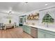 Bright kitchen featuring green cabinetry, open shelving, and stainless steel appliances at 425 Shelby Ln, Hiram, GA 30141