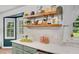 Kitchen featuring a white countertop, a large window, and decorative wooden shelves at 425 Shelby Ln, Hiram, GA 30141