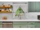 Kitchen featuring a white countertop, a large window, and decorative wooden shelves at 425 Shelby Ln, Hiram, GA 30141